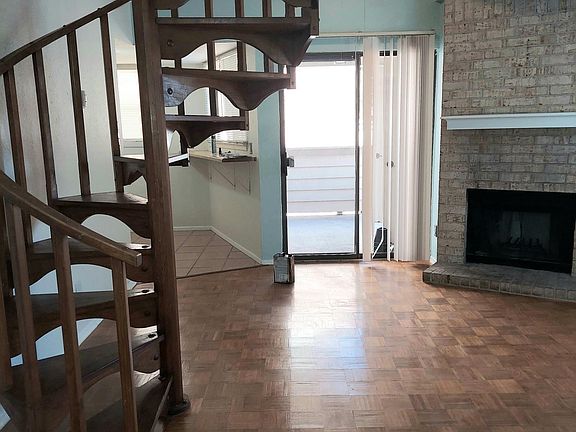 Looking from front door towards kitchen and patio. Fireplace on the right.