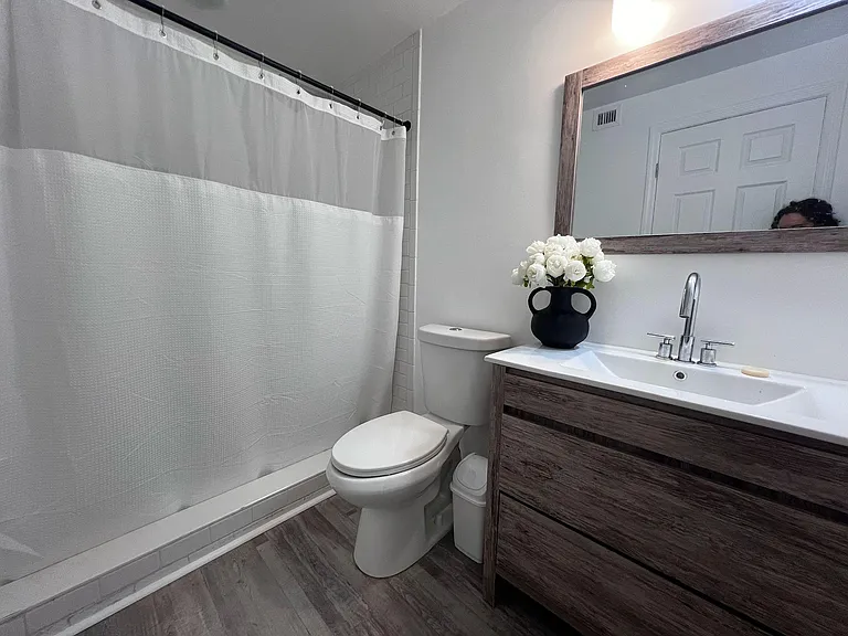 Spacious bathroom with walk in tiled shower.