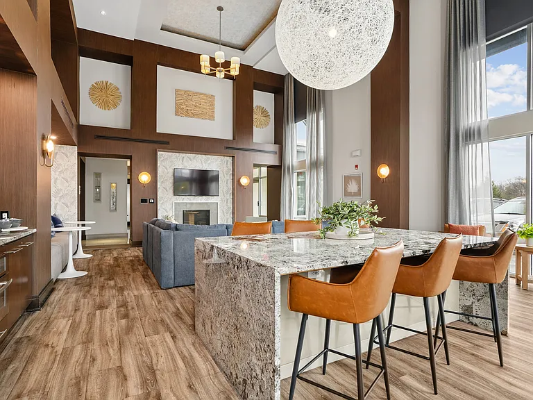 Resident lounge with coffee bar, seating, TVs and fireplace