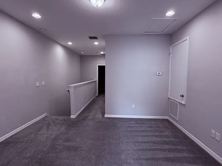 Loft showing staircase and entrance to master suite