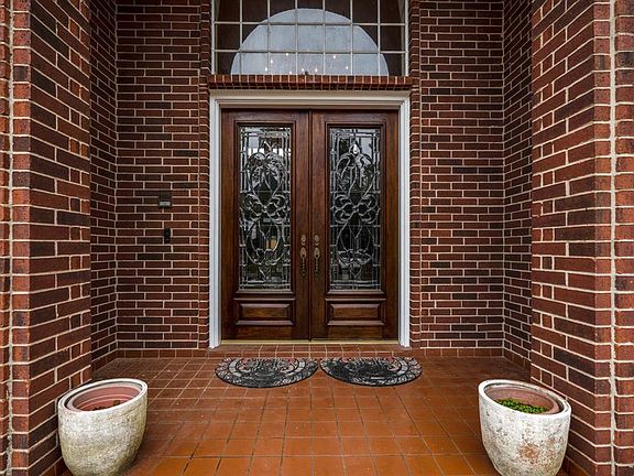The covered front porch leads you into the double leaded glass and wood doors.