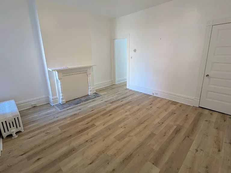 1st Floor Dining Room w/ natural stone hearth & fireplace, the door to the right leads to the full, dry basement (inquire for photos of excellent basement for storage and washer/dryer area)