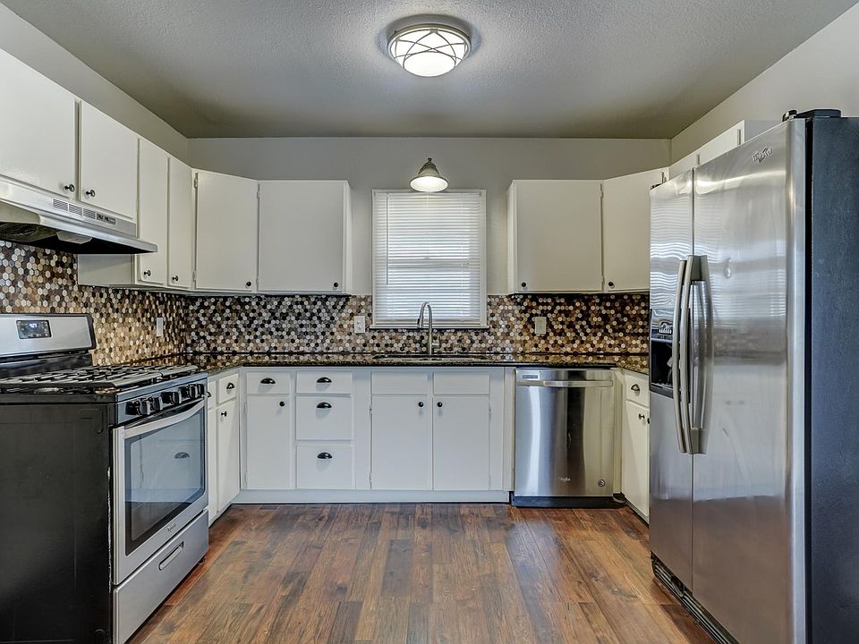 Kitchen features stainless steel appliances and granite countertops. Plenty of countertop and cabinets.