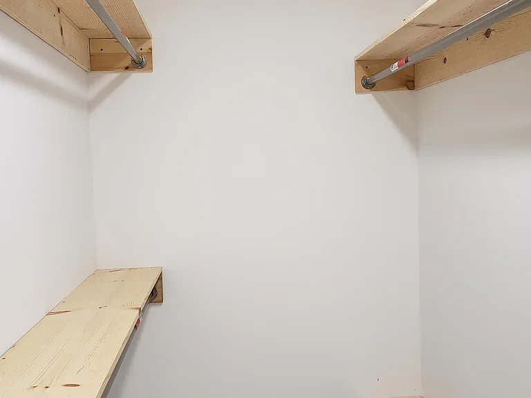 Third view of the large, walk-in closet in the master bedroom.