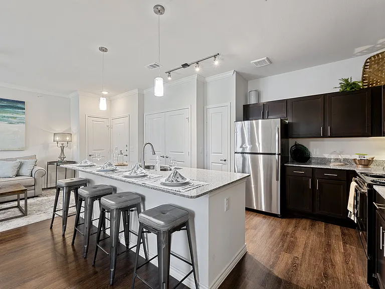 Granite countertops and breakfast bar seating create a stylish entertaining space.