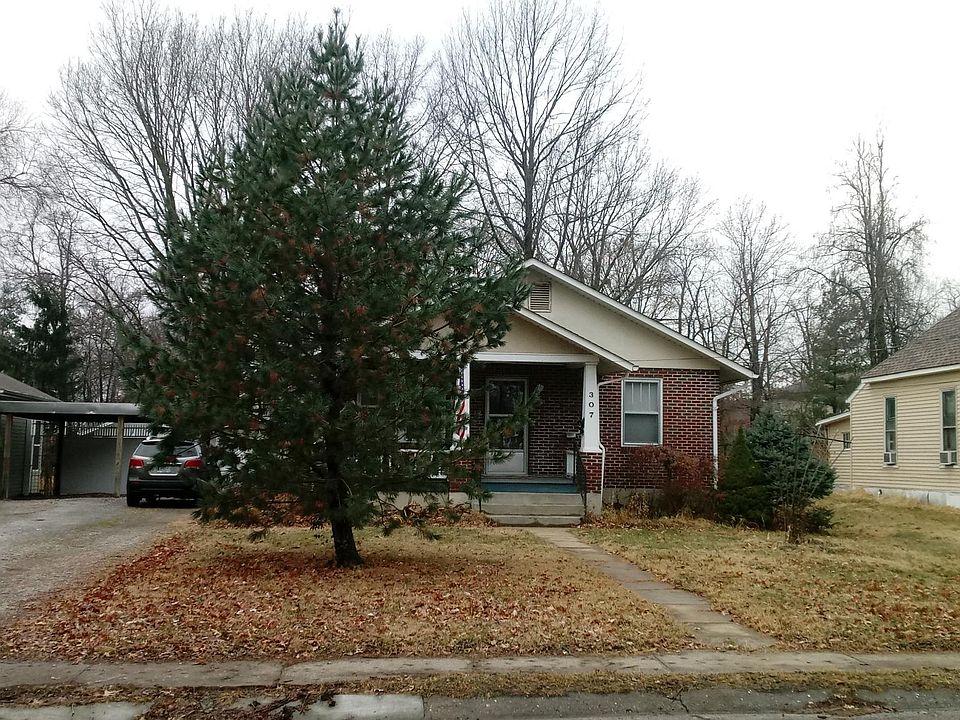 Front of house, driveway to left