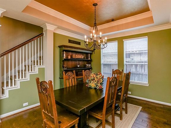 The dining room is spacious yet cozy, great for large gatherings or daily enjoyment.  Tray ceiling with double crown molding, accented by an elegant with designer chandelier.