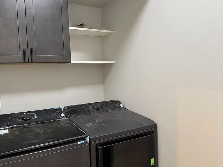 Laundry room with new washer and dryer