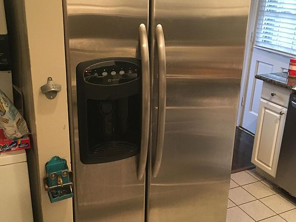 Side-by-side refrigerator with ice and water in the door