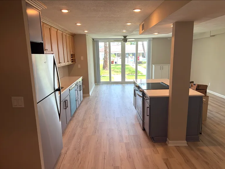 Open kitchen, dining, gathering area. New high-impact sliders.