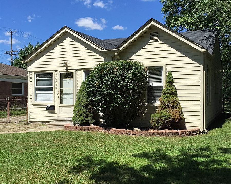 Front of house with bushes.