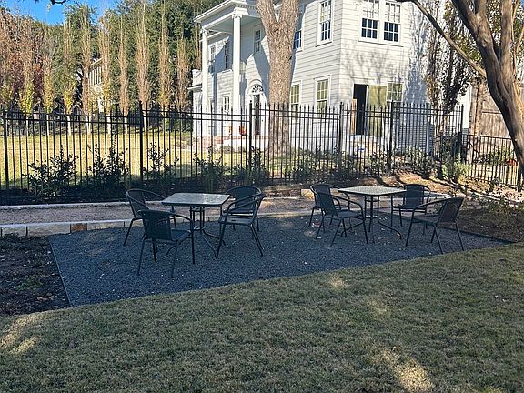 Gated yard with sitting area, bocce ball court and garden!