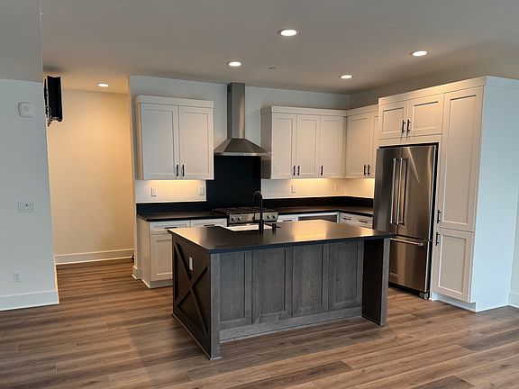 The kitchen is the heart of the unit, measuring ~13' x 8'