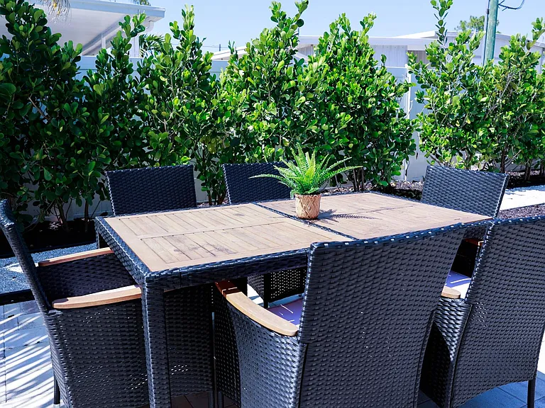 The outdoor dining area for up to 6 people sits under a sun screen for those relaxing meals outside.