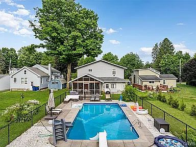 Fenced inground pool sitting right behind your screened in porch