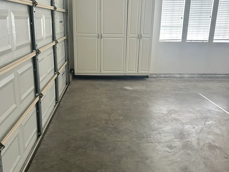 Garage with lots of storage cabinets, freshly painted