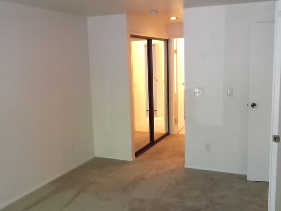 Walk in closet with mirrored doors