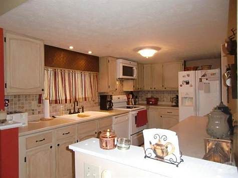 --Updated kitchen includes loads of cabinets and counter space, new mosaic tile back splash and comes equipped!