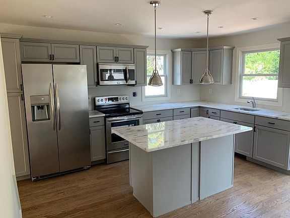 Recently installed kitchen and appliances with marble counters