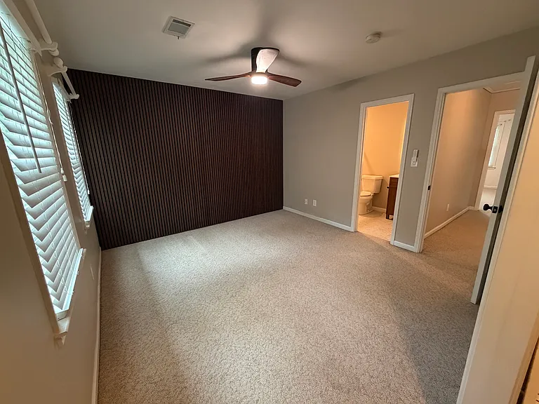 Front bedroom with a full bathroom and closet with built-ins.