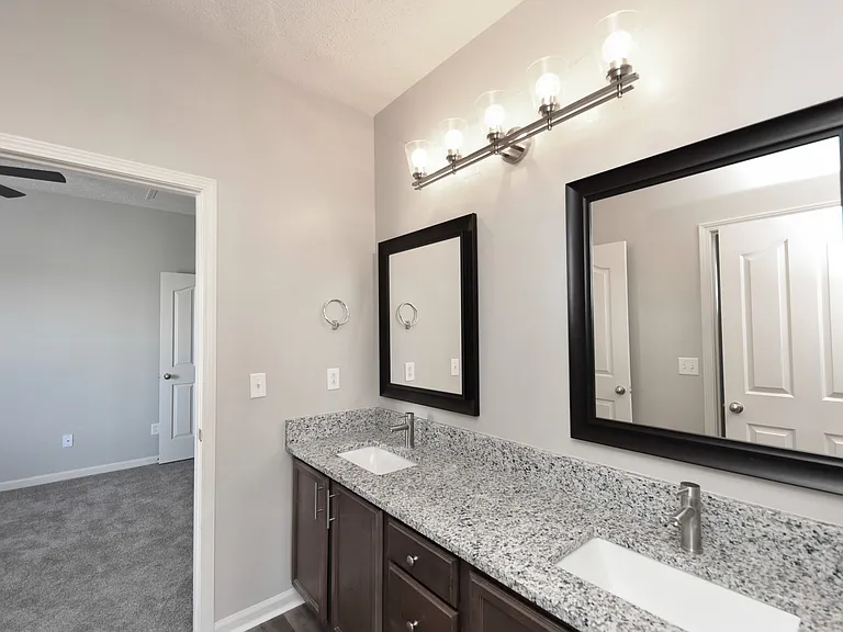 Bright bathroom with granite counters & modern cabinetry