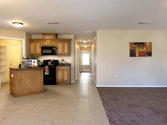 The view as you enter the home. The living room is to the right and the kitchen is a fantastic open concept. This is great when entertaining family and friends.