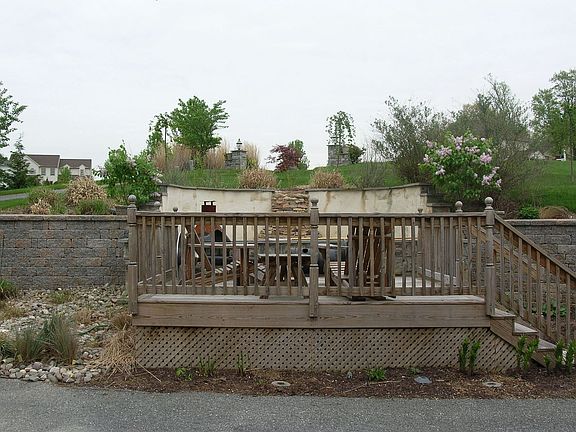 deck off of pond in front of house