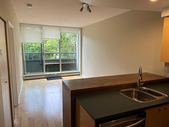 View from the kitchen to the lounge and out onto the balcony.