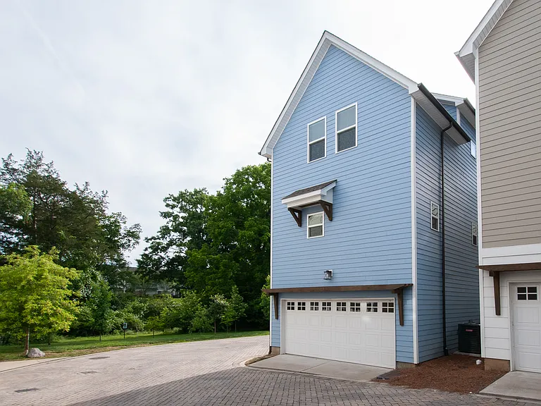 View of the back of the house with the alley access to the garage.