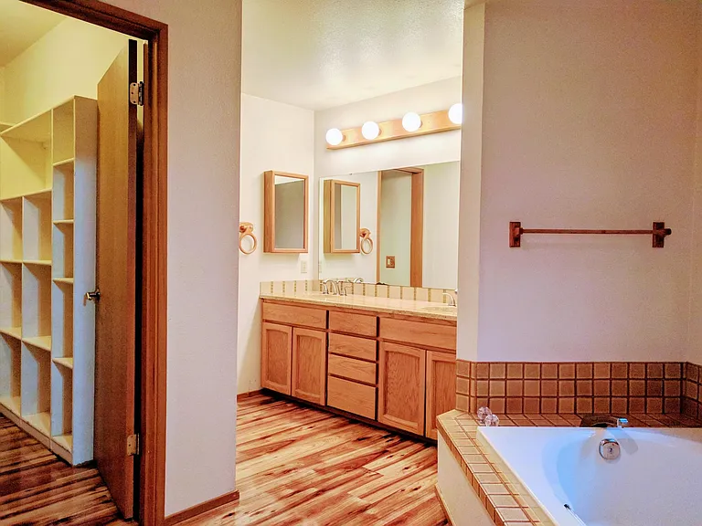 5-piece master bathroom and closet with built-in shelves.