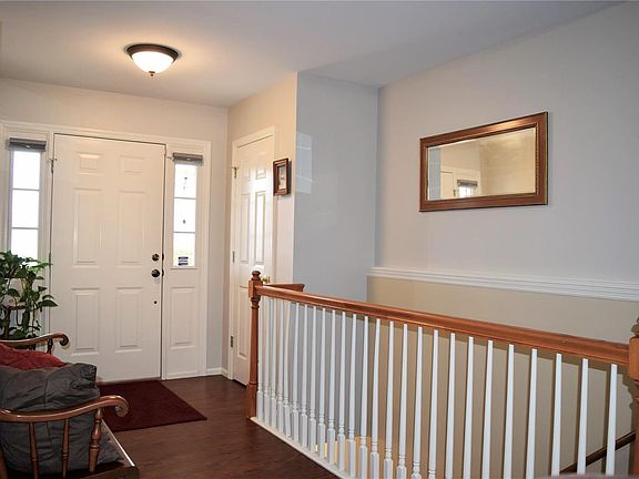 Foyer with NEW hand-scraped wood flooring. Spindled stairway to the finished LL.
