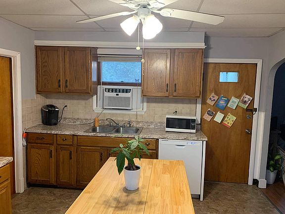 Kitchen with door to side entrance ,shed and courtyard area