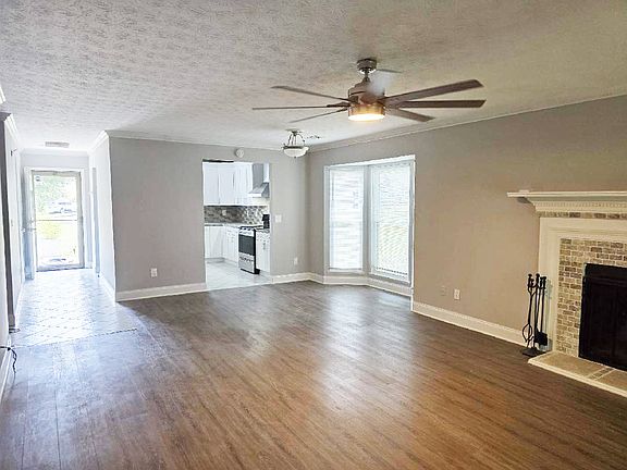 Living room looking at kitchen and front door.