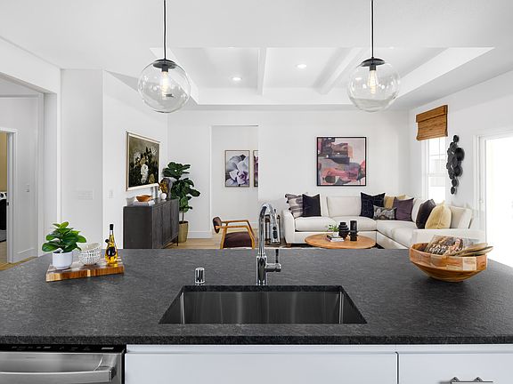 Kitchen with undermount stainless steel sink and pendant lighting