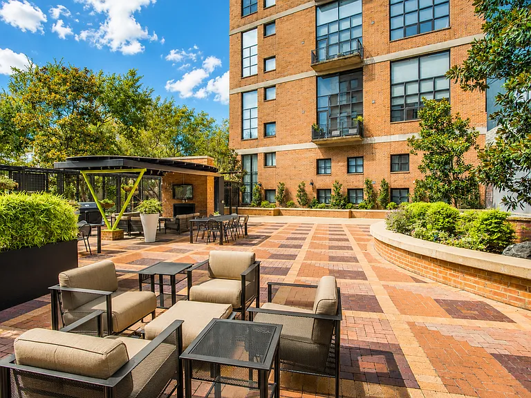 Unwind on a terrace designed for ultimate relaxation and entertainment, featuring a cozy fireplace, charming cafe lights, BBQ grills, and a TV_your perfect outdoor oasis.