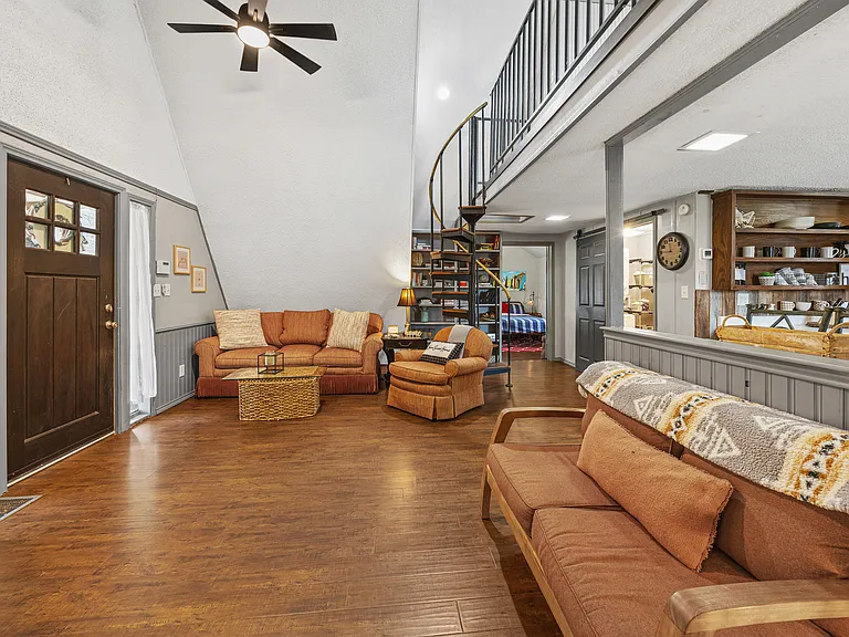 Cozy living area with couches and comfy swivel chair
