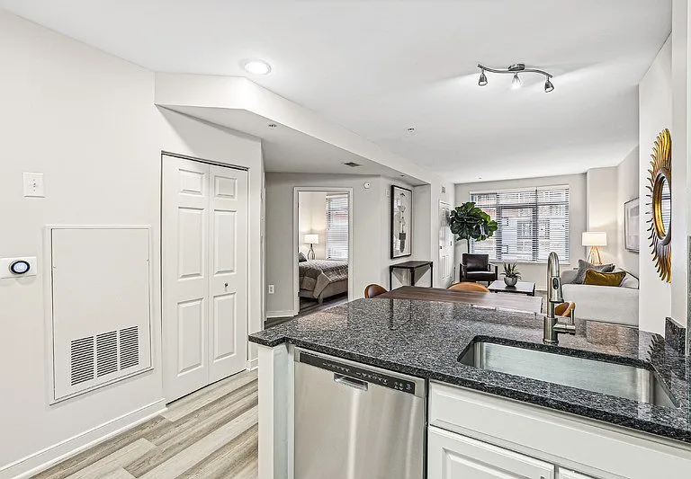 View from Kitchen Toward Bedroom, Dining Table, and Windowed Living Room