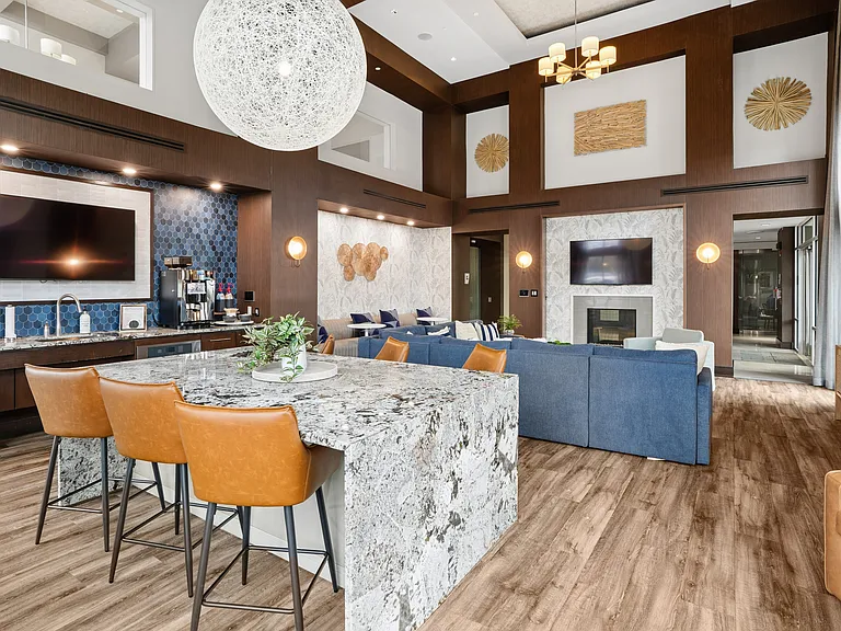 Resident lounge with coffee bar, TVs and fireplace