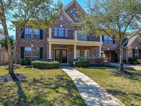 Enter into your beautiful home with iron accented glass double doors. The balcony is both pretty and accessible. Shutters accent