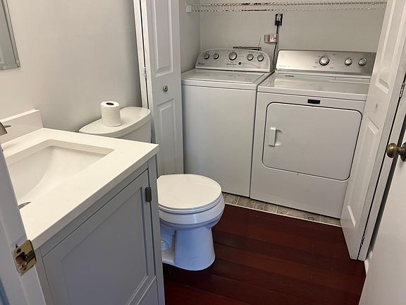 Downstairs half bathroom with washer and dryer.