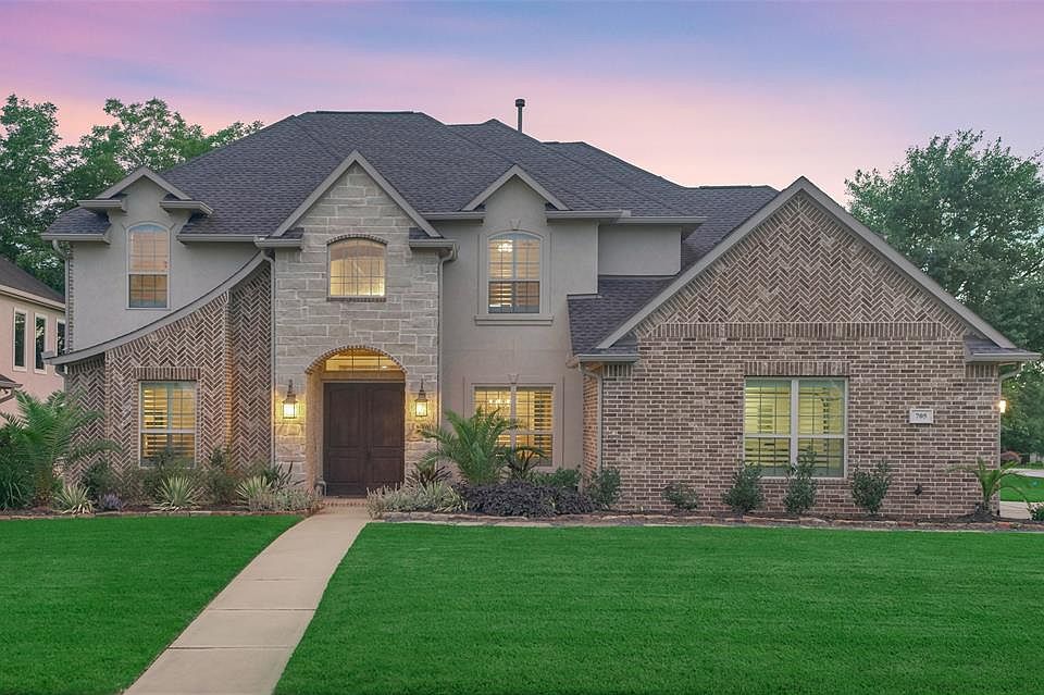 English Manor inspired Custom Home reflects true modern elegance and is located in the premier gated lake community of Bentwater. Welcome to 705 Edgewood Drive!