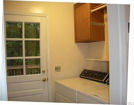 Laundry room features a valet bar, new cabinets, and pantry