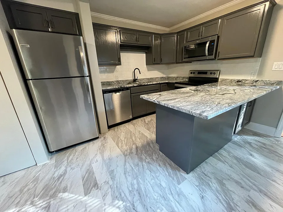 Completely new kitchen with all new cabinetry, solid surface counter tops with over hang for bar stools, new stainless steel appliances, and tile flooring
