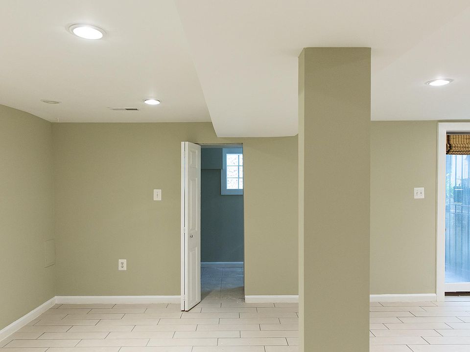 Living room / dining room; storage closet or office in the background.