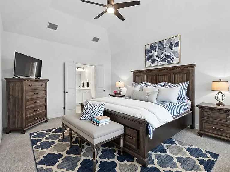 Primary bedroom is so spacious, plenty of room for a king size bed and overlooks the backyard with trees in view! This photo has some virtual staging.