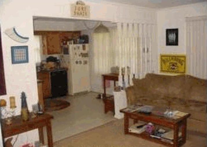 Taken from inside den and shows partial of the kitchen.