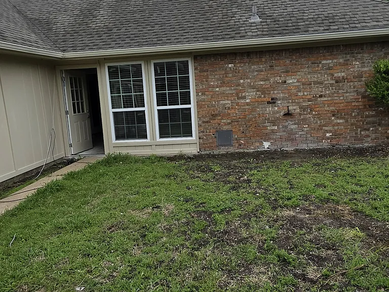 large private back yard with fence and shed