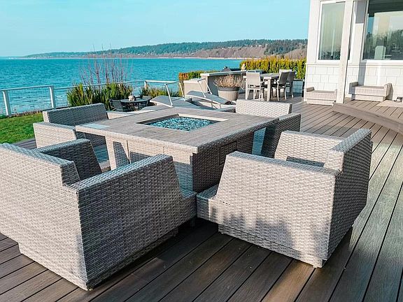 OUTDOOR LIVING at its finest, includes over 1000 SQUARE FEET DECK, porch swing, propane fire table, grill, bbq, griddle, green egg, sink and more.