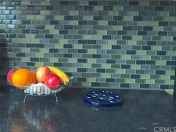 Glass Tiled Backsplash.  Composite Granite Counters.