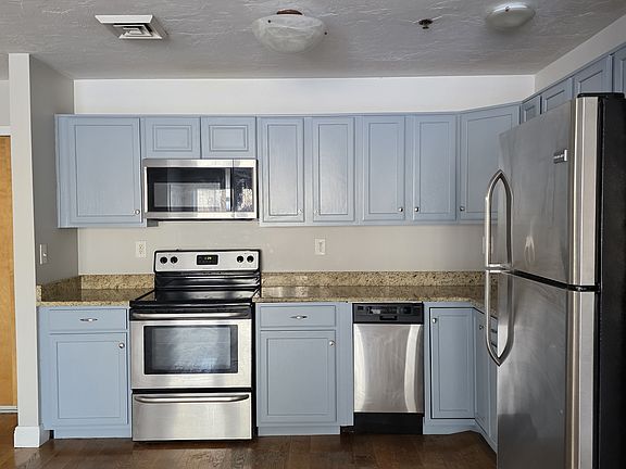 Kitchen with stainless steel appliances, view from the living room